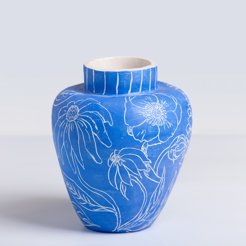 Ceramic vase with white flowers on matte klein blue background, handmade and painted in a unique style by Spanish artist Maite Morell.