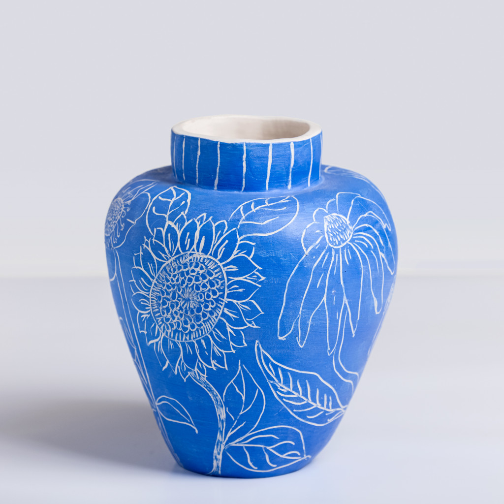 Ceramic vase with white flowers on matte klein blue background, handmade and painted in a unique style by Spanish artist Maite Morell.