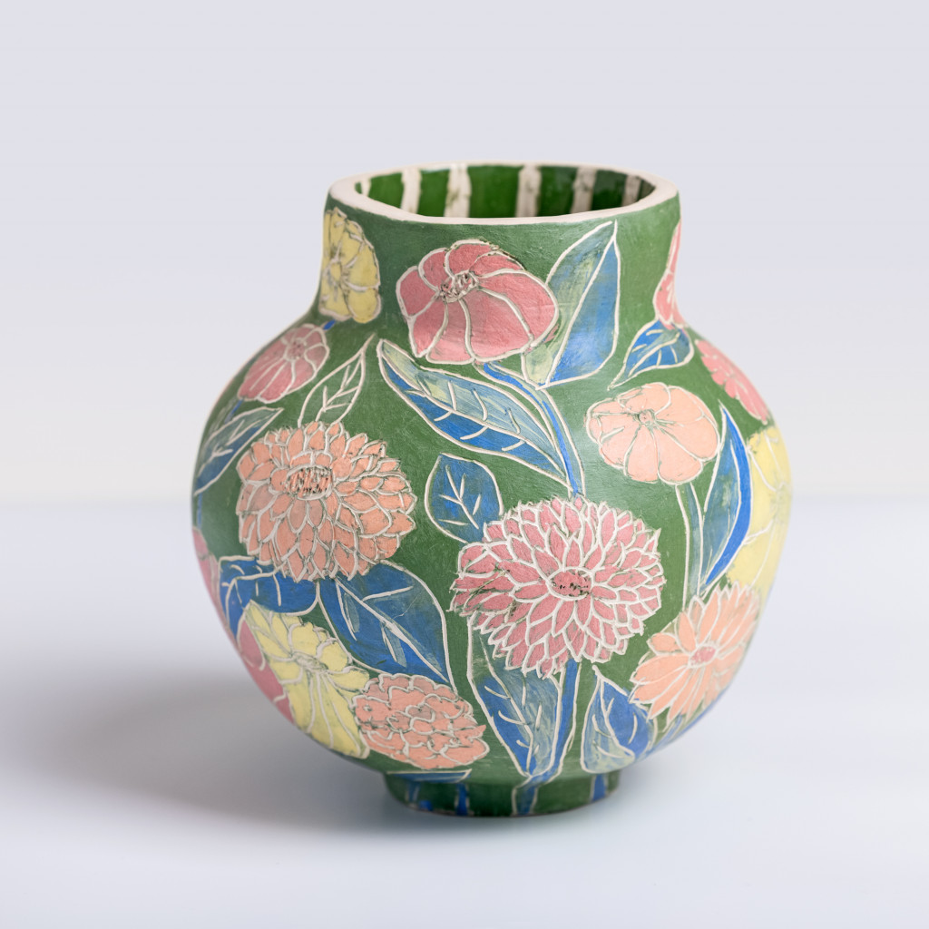 Ceramic vase with colorful flowers on matte green background, handmade and painted in a unique style by Spanish artist Maite Morell.