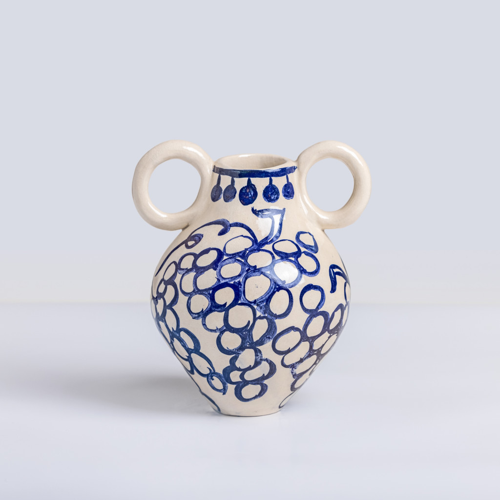 Ceramic vase with blue grapes on white background, handmade and painted in a unique style by Spanish artist Maite Morell.