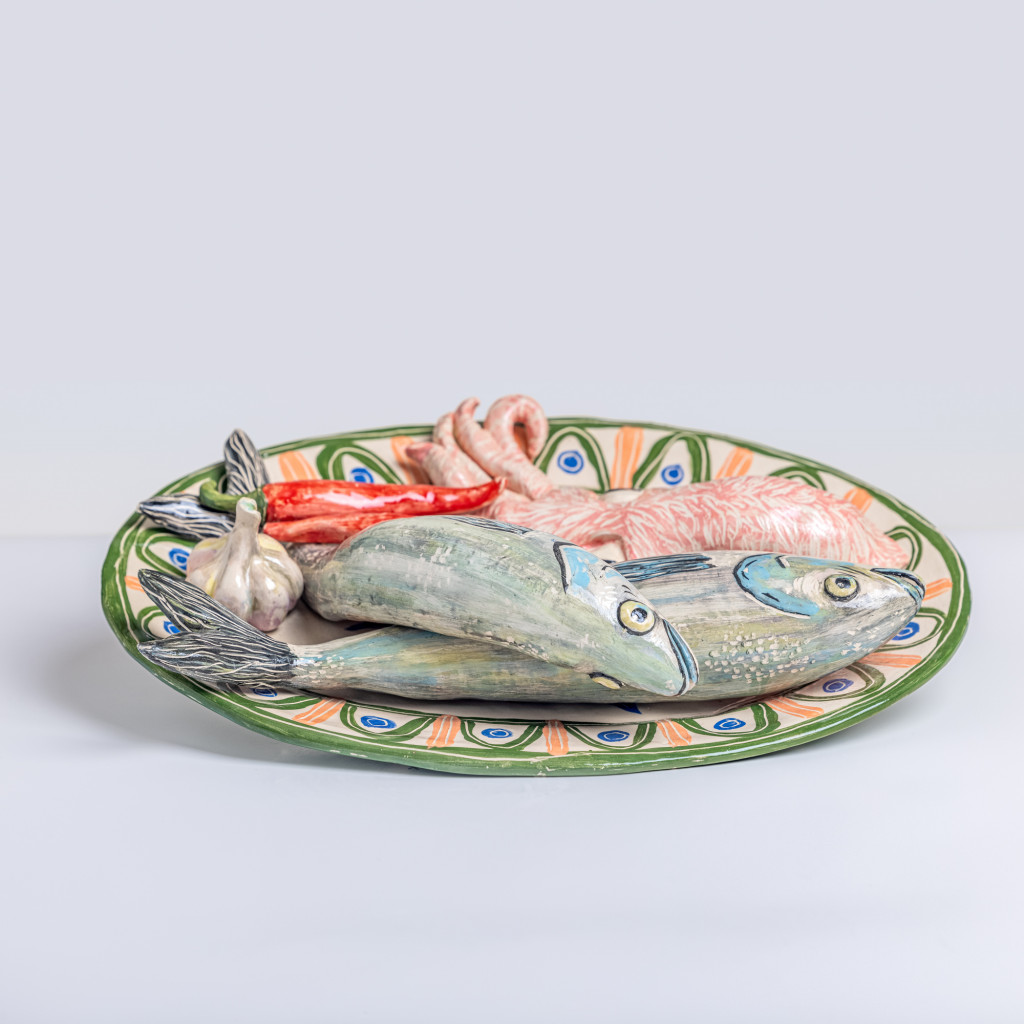 Ceramic still life with sea bass, cuttlefish, chili and a head of garlic, handmade and painted in a unique & colourful style by Spanish artist Maite Morell.
