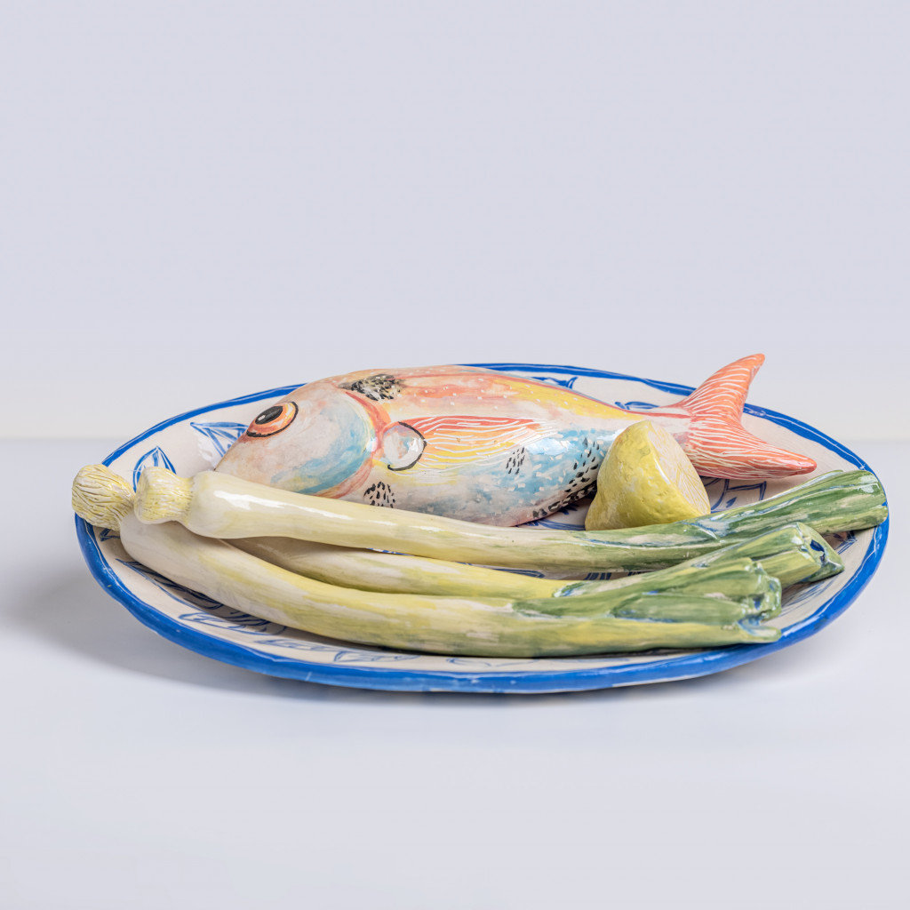 Ceramic still life with sea bream, leeks and half a lemon, handmade and painted in a unique & colourful style by Spanish artist Maite Morell.
