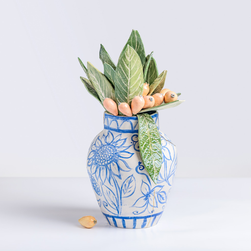 Ceramic still life of a chinese vase with loquat branches, handmade and painted in a unique & colourful style by Spanish artist Maite Morell.
