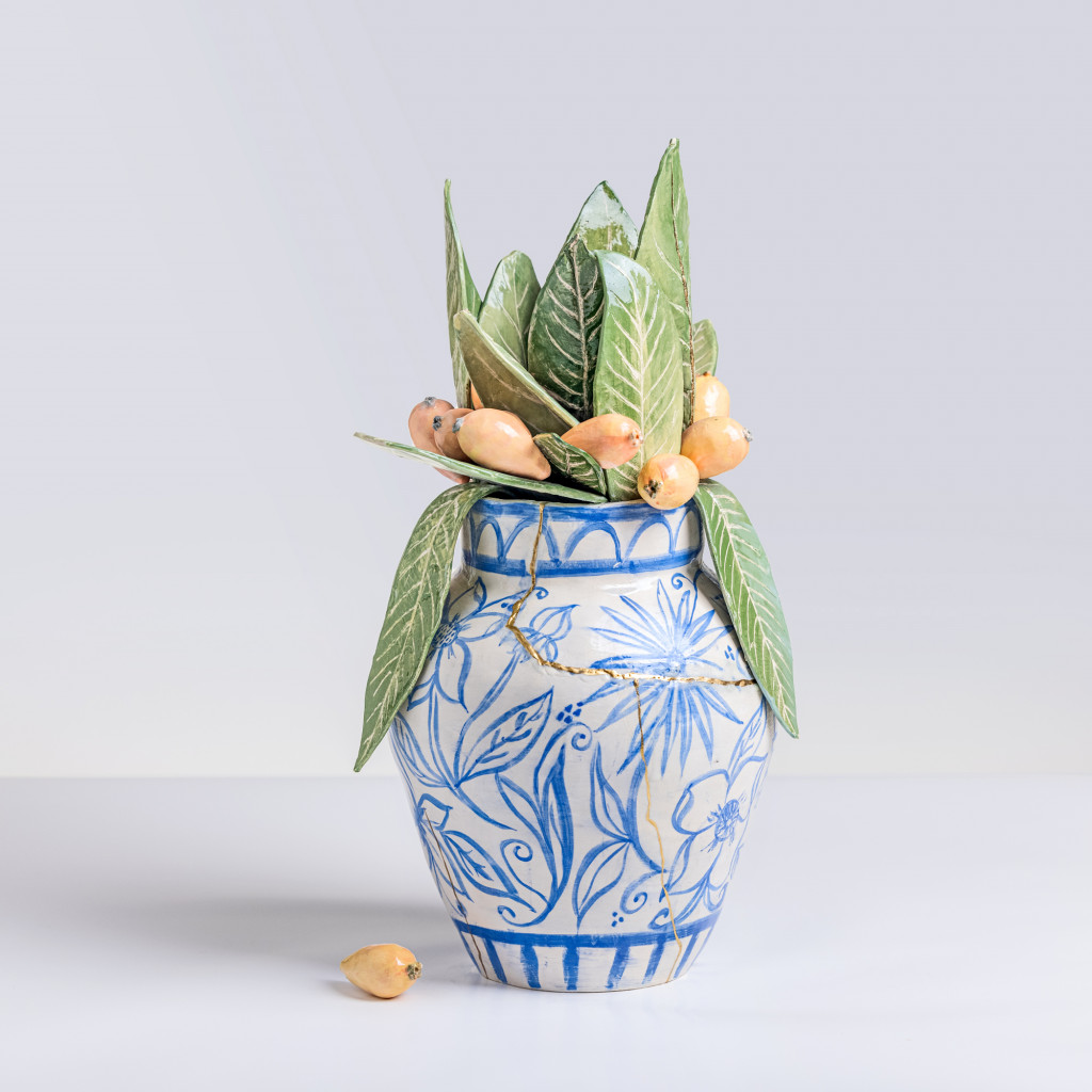Ceramic still life of a chinese vase with loquat branches, handmade and painted in a unique & colourful style by Spanish artist Maite Morell.