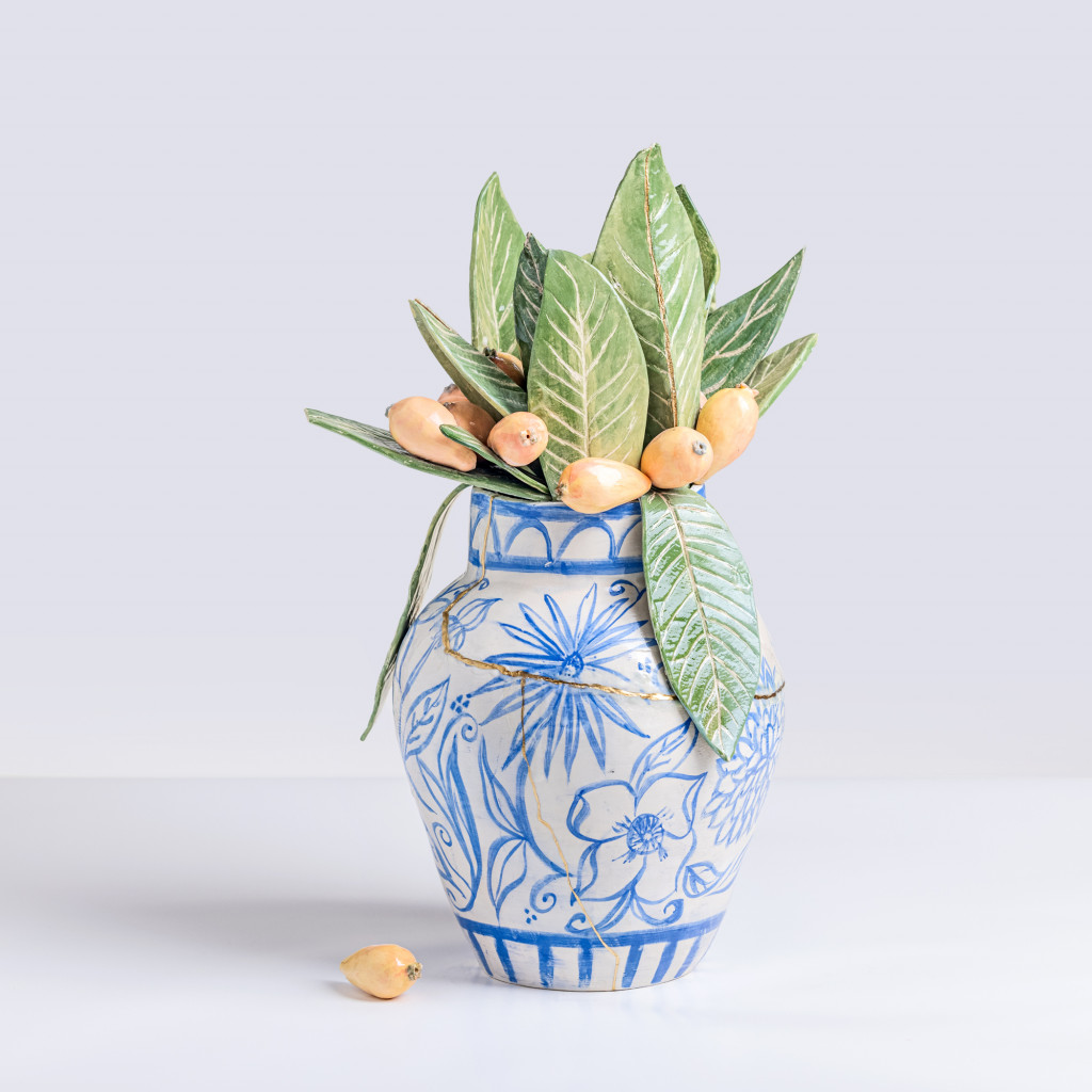 Ceramic still life of a chinese vase with loquat branches, handmade and painted in a unique & colourful style by Spanish artist Maite Morell.
