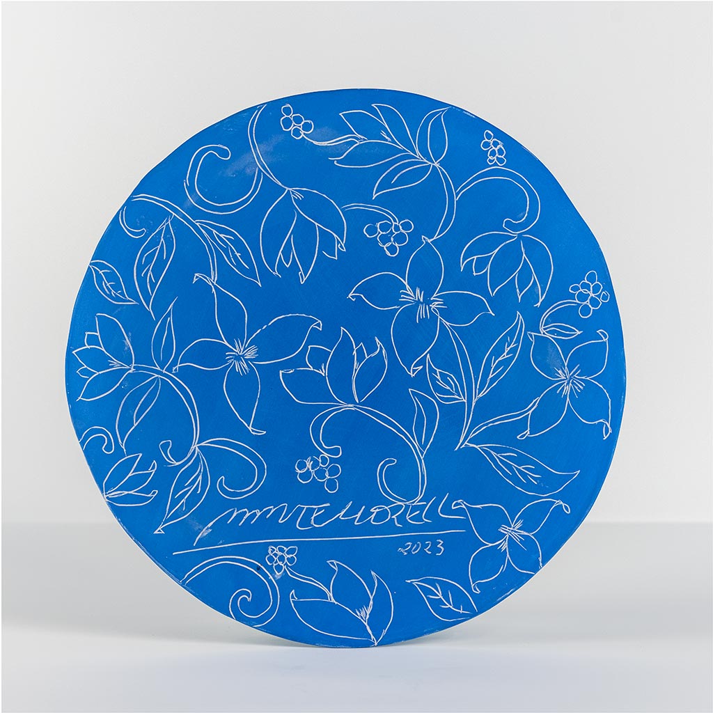 Ceramic decorative plate with self portrait on blue background, handmade and painted in a unique & colourful style by Spanish artist Maite Morell.