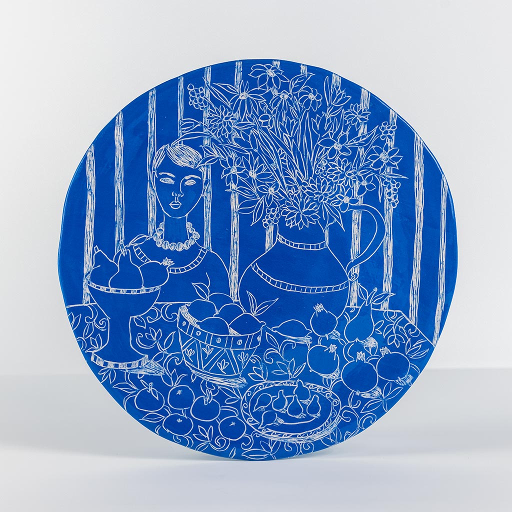 Ceramic decorative plate with self portrait on blue background, handmade and painted in a unique & colourful style by Spanish artist Maite Morell.