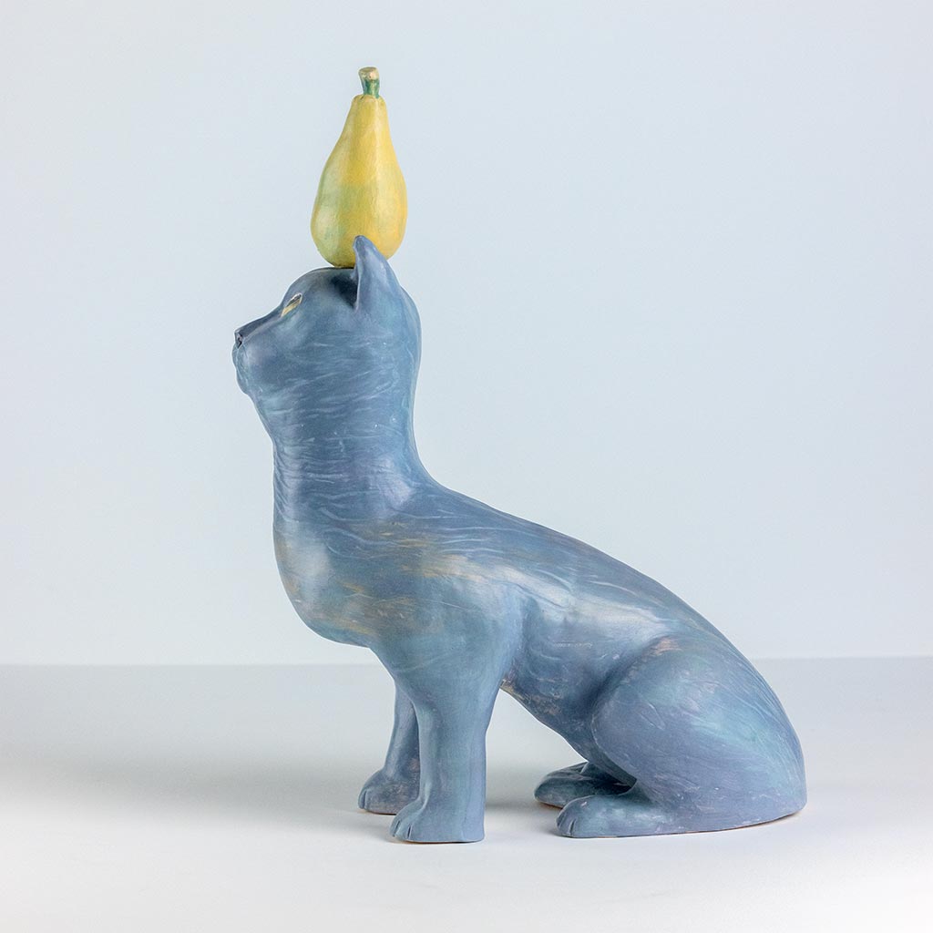 Ceramic sculpture of a cat with a pear, handmade and painted in a unique style by Spanish artist Maite Morell.