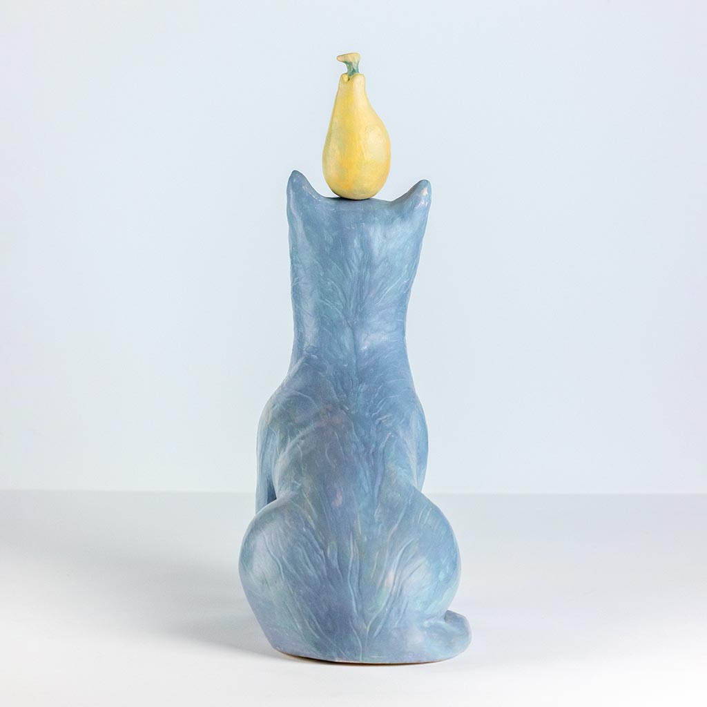 Ceramic sculpture of a cat with a pear, handmade and painted in a unique style by Spanish artist Maite Morell.