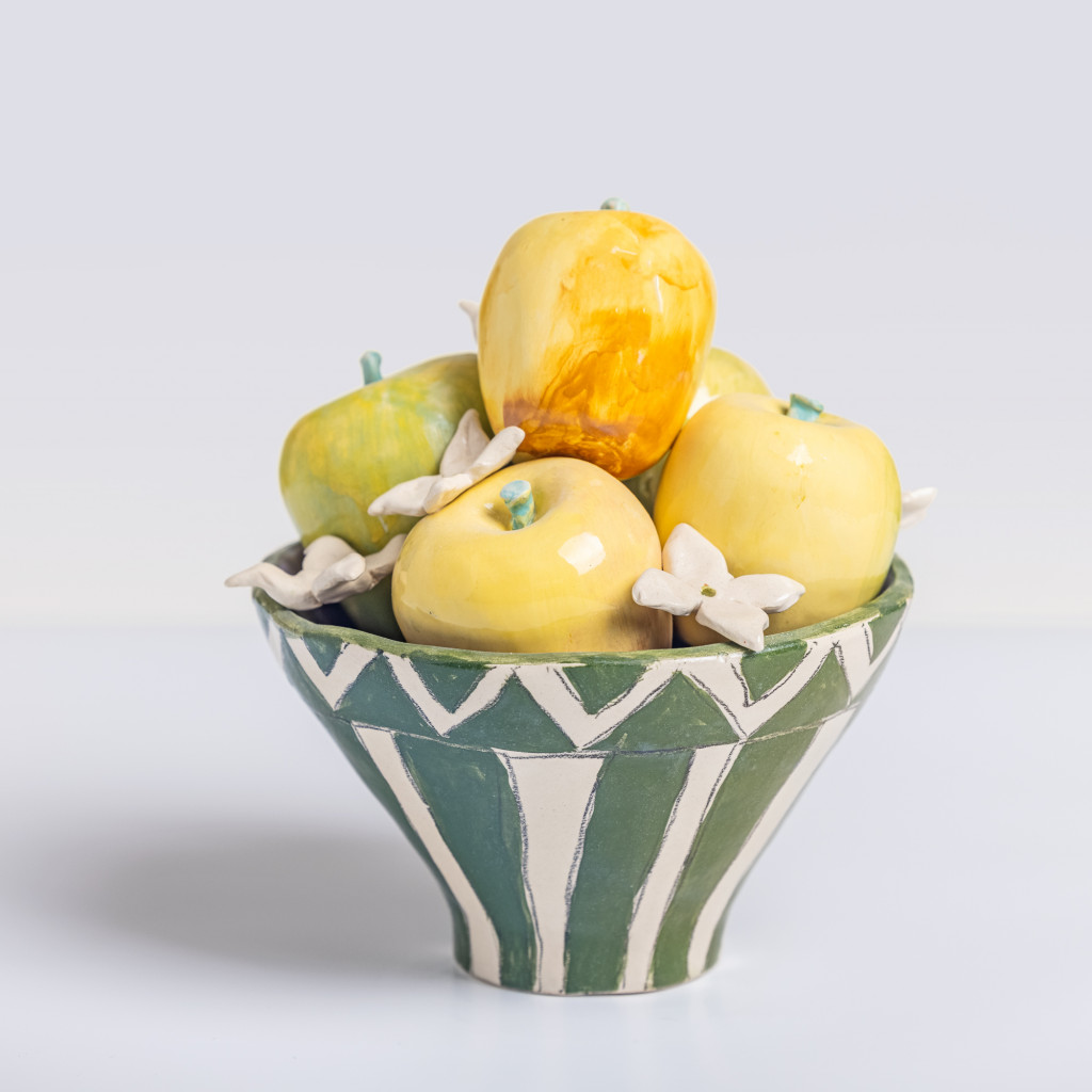 Ceramic still life with a bowl of green apples and orange blossoms, handmade and painted in a unique & colourful style by Spanish artist Maite Morell.