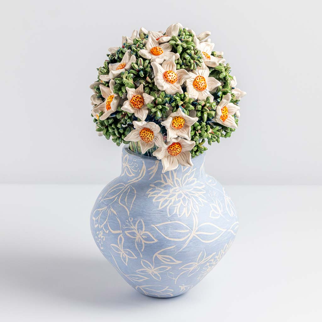 Ceramic still life of a blue vase and white flowers, handmade and painted in a unique & colourful style by Spanish artist Maite Morell.