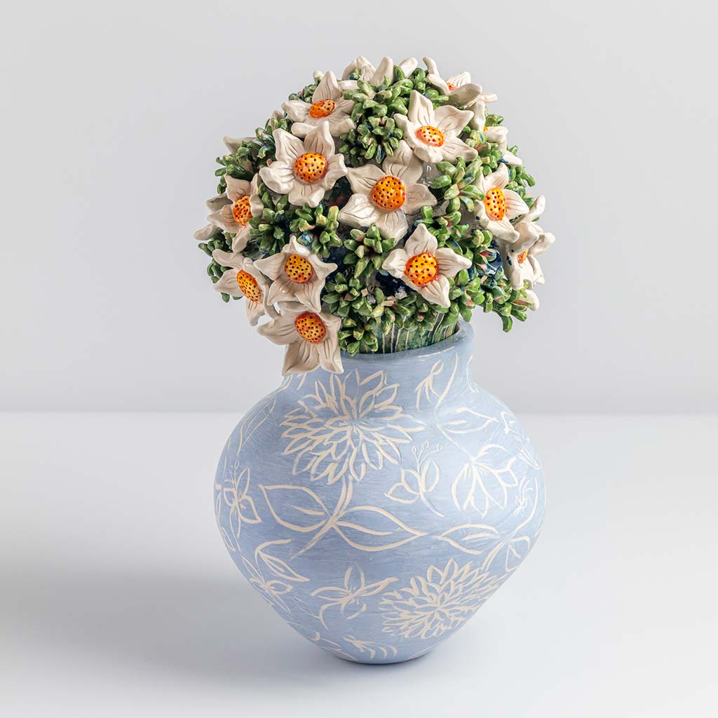 Ceramic still life of a blue vase and white flowers, handmade and painted in a unique & colourful style by Spanish artist Maite Morell.
