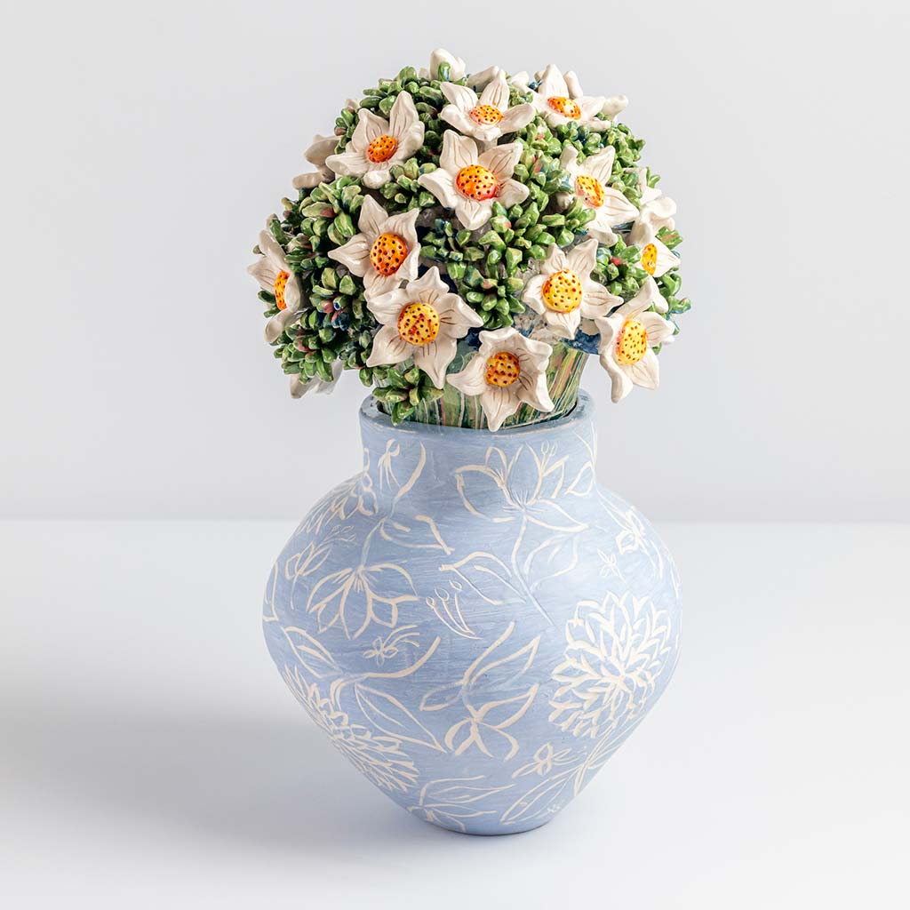 Ceramic still life of a blue vase and white flowers, handmade and painted in a unique & colourful style by Spanish artist Maite Morell.
