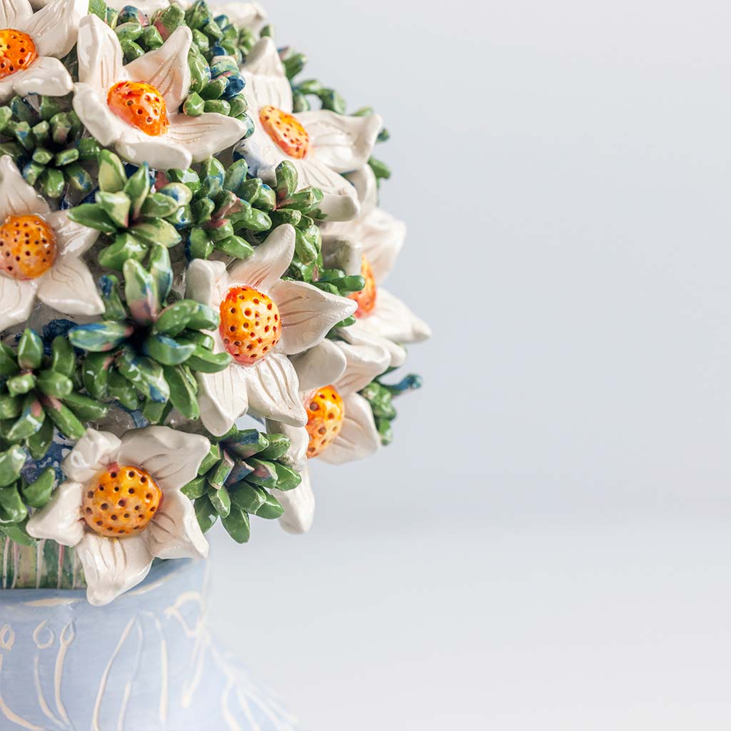 Ceramic still life of a blue vase and white flowers, handmade and painted in a unique & colourful style by Spanish artist Maite Morell.