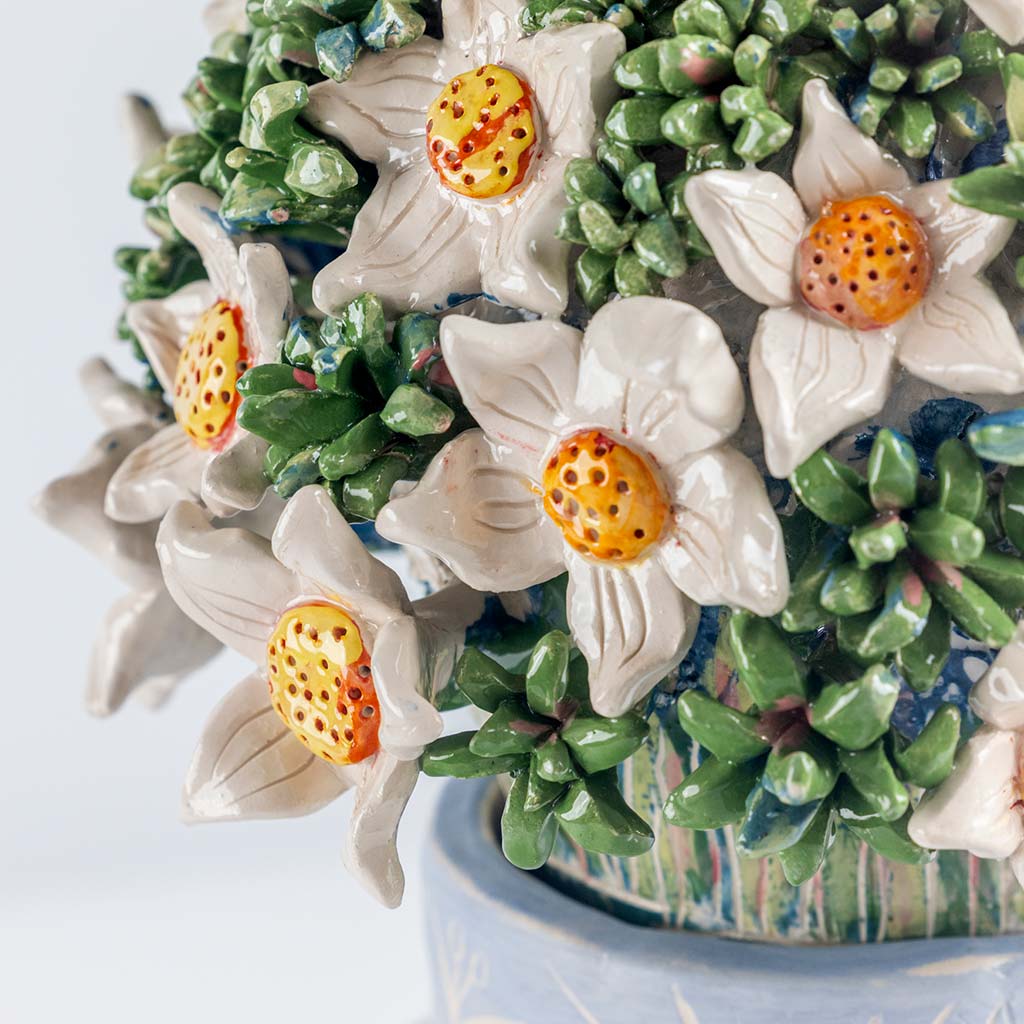 Ceramic still life of a blue vase and white flowers, handmade and painted in a unique & colourful style by Spanish artist Maite Morell.