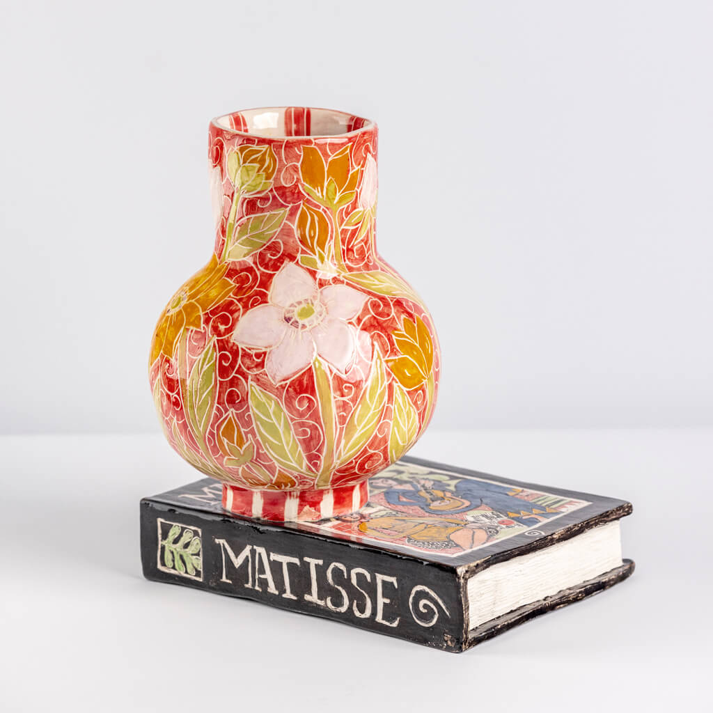 Ceramic still life of a book of Matisse with red vase, handmade and painted in a unique & colourful style by Spanish artist Maite Morell.