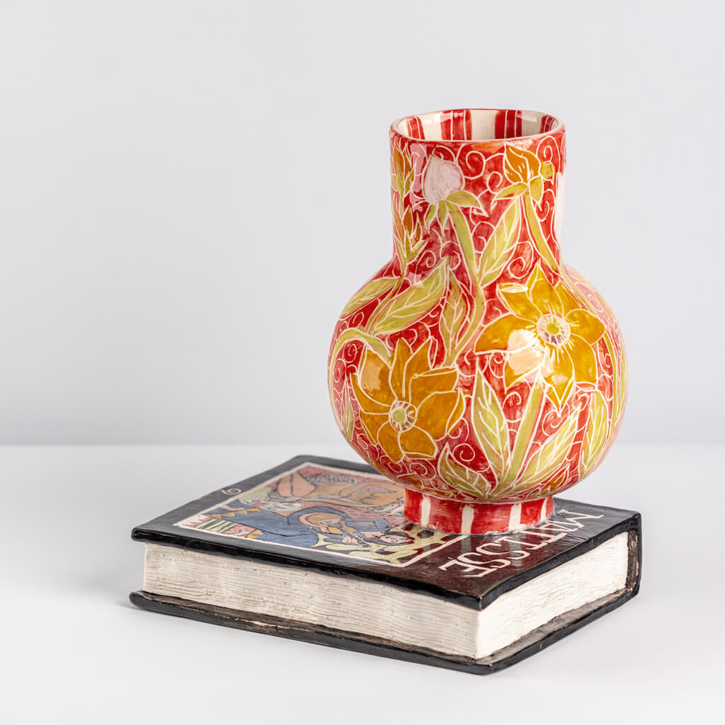 Ceramic still life of a book of Matisse with red vase, handmade and painted in a unique & colourful style by Spanish artist Maite Morell.