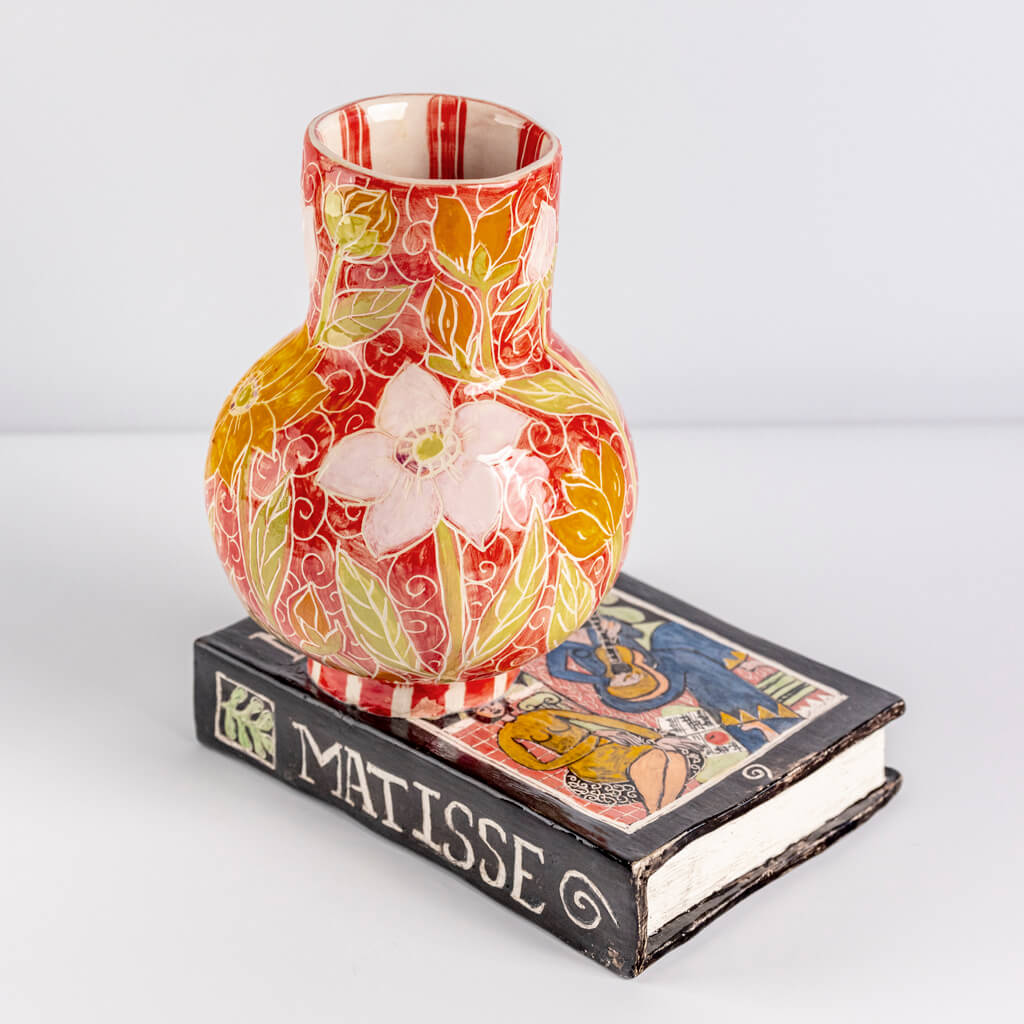 Ceramic still life of a book of Matisse with red vase, handmade and painted in a unique & colourful style by Spanish artist Maite Morell.