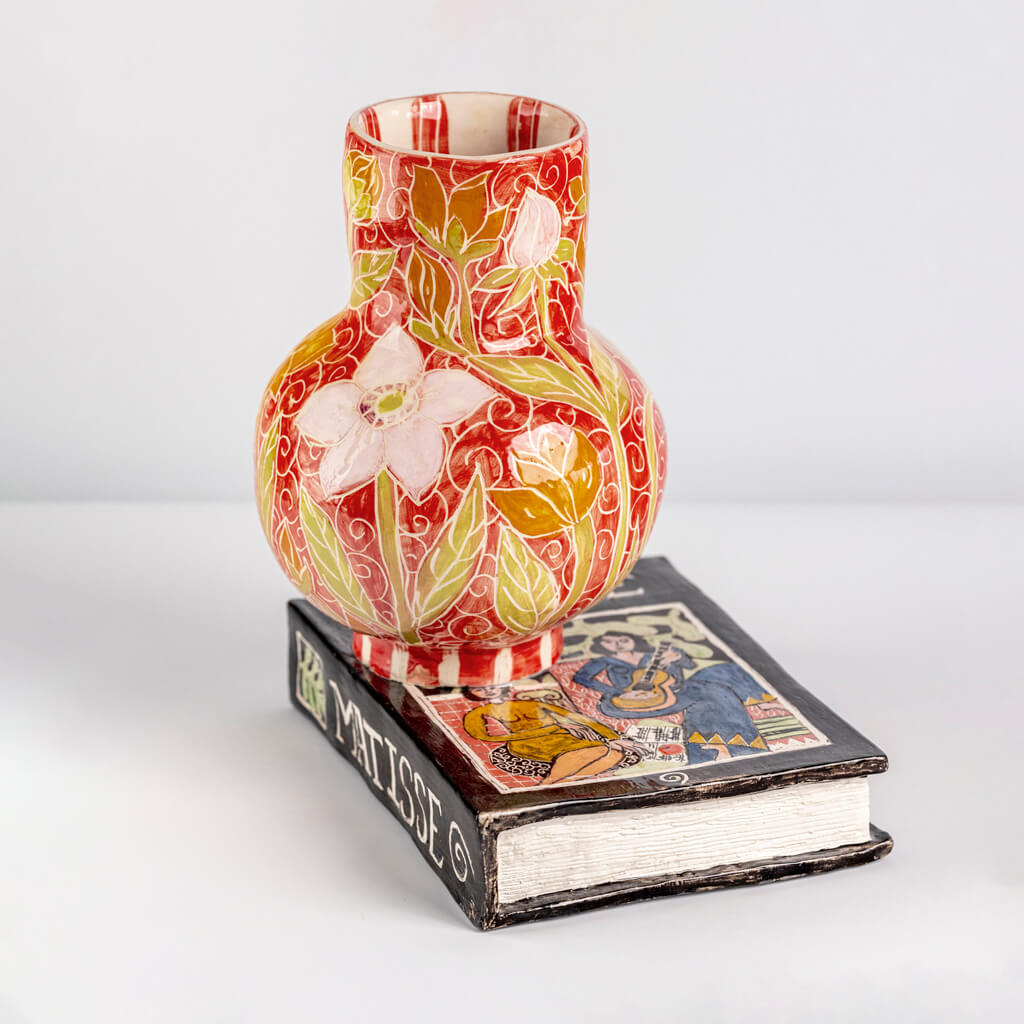 Ceramic still life of a book of Matisse with red vase, handmade and painted in a unique & colourful style by Spanish artist Maite Morell.