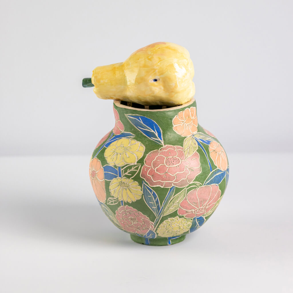 Ceramic still life of a green vase and yellow pear, handmade and painted in a unique & colourful style by Spanish artist Maite Morell.