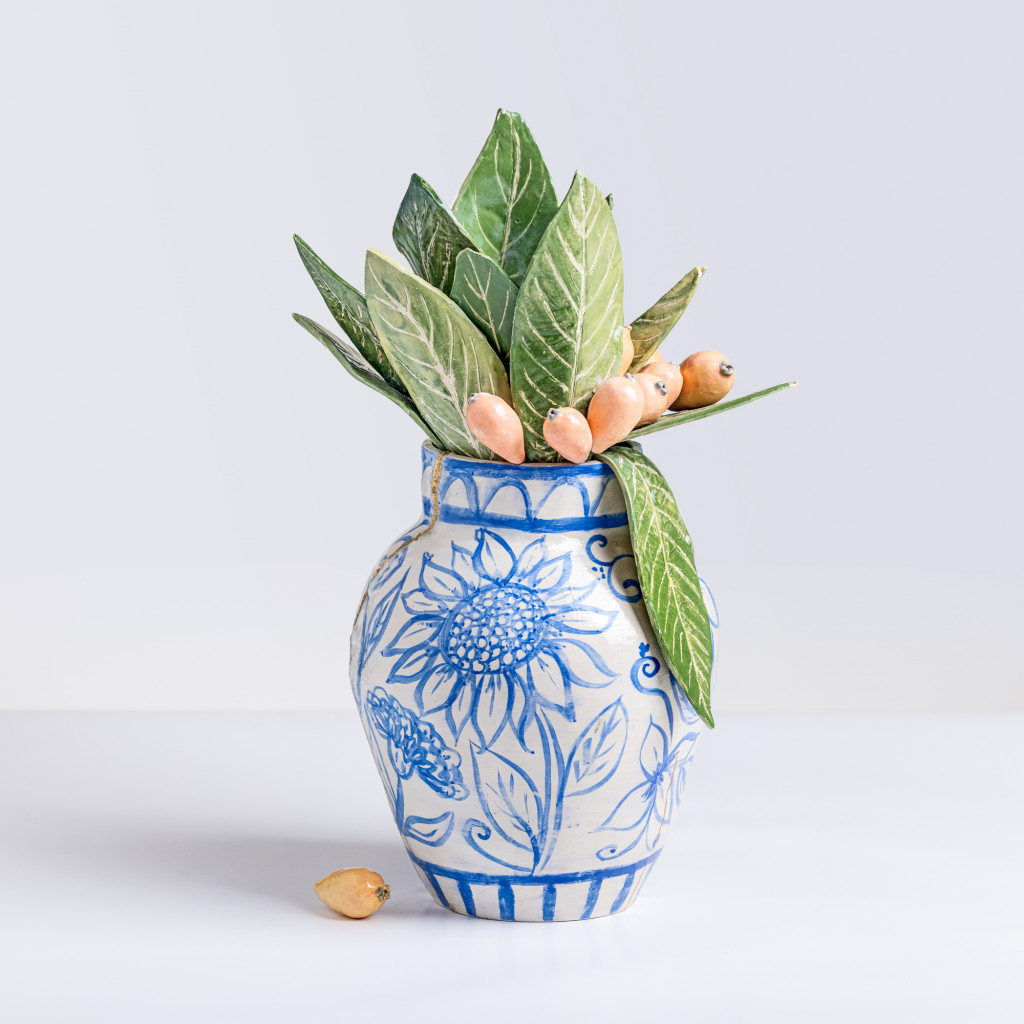 Ceramic still life of a chinese vase with loquat branches, handmade and painted in a unique & colourful style by Spanish artist Maite Morell.