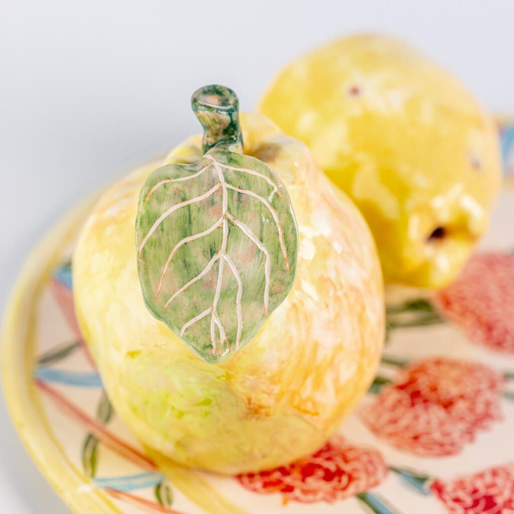 Ceramic still life of a plate of carnations and two quinces, handmade and painted in a unique & colourful style by Spanish artist Maite Morell.