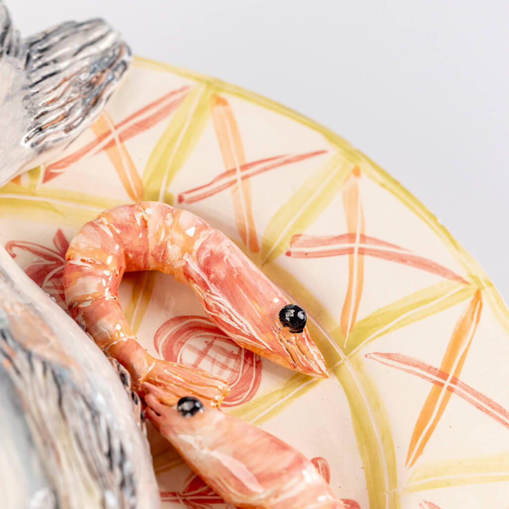 Ceramic still life of a plate of fish, prawns and lemon, handmade and painted in a unique & colourful style by Spanish artist Maite Morell.