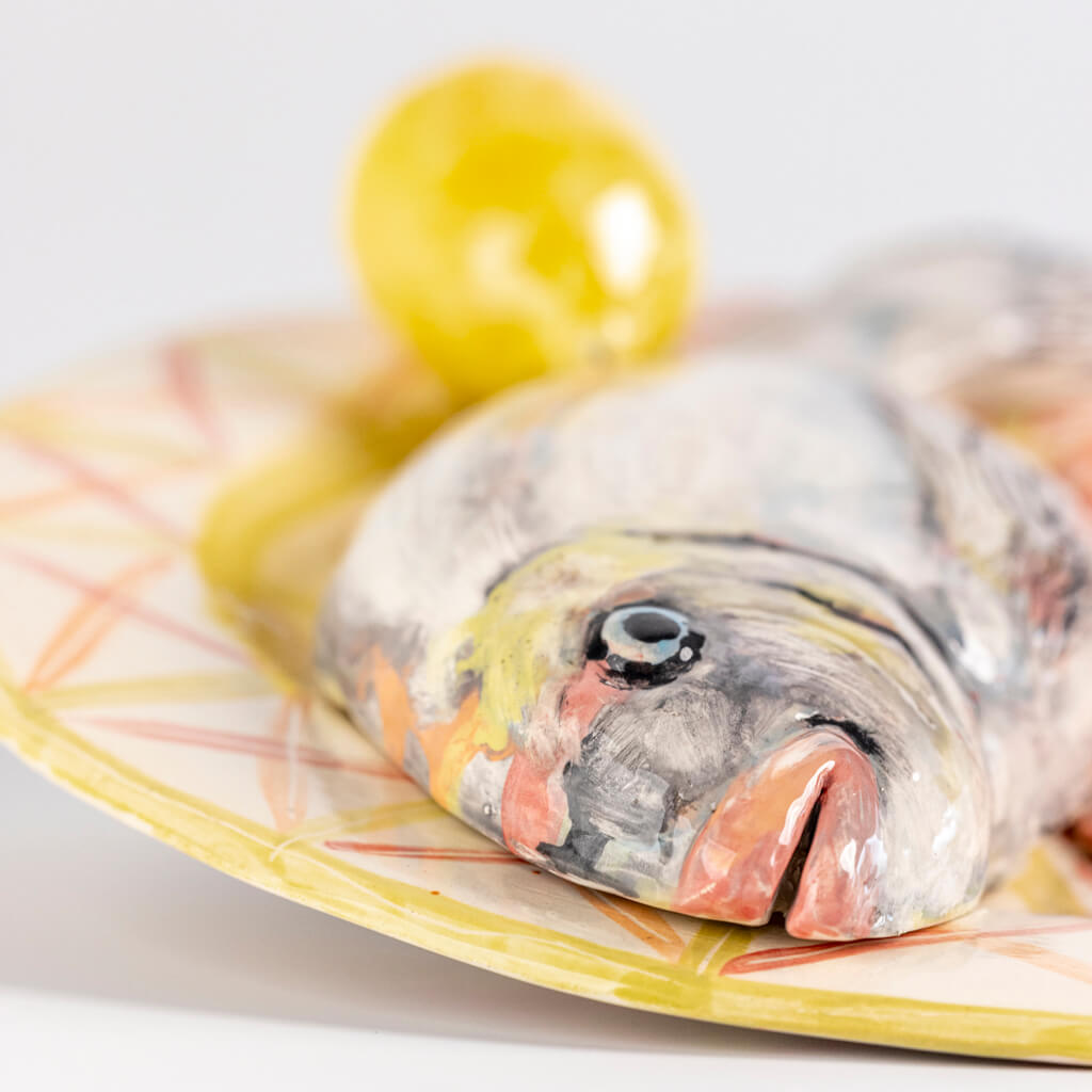 Ceramic still life of a plate of fish, prawns and lemon, handmade and painted in a unique & colourful style by Spanish artist Maite Morell.