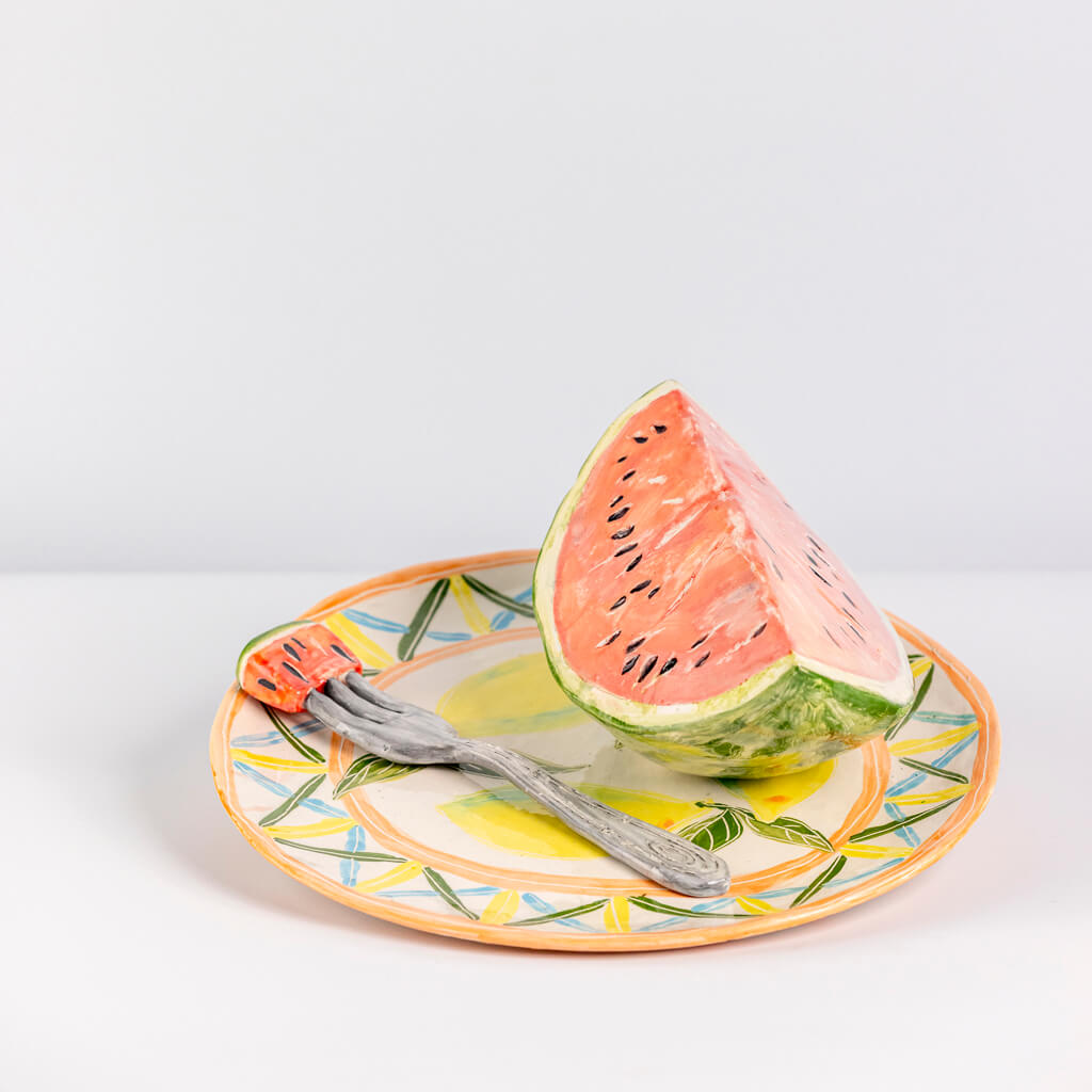 Ceramic still life of a plate of watermelon and a fork, handmade and painted in a unique & colourful style by Spanish artist Maite Morell.