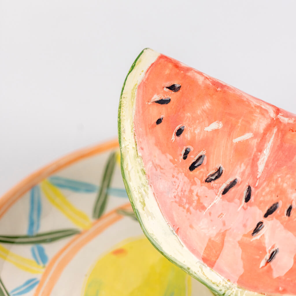 Ceramic still life of a plate of watermelon and a fork, handmade and painted in a unique & colourful style by Spanish artist Maite Morell.