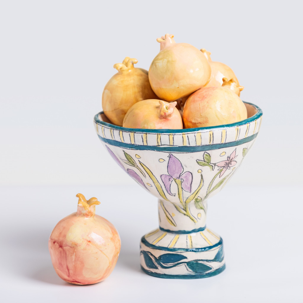 Ceramic still life of a vase with pomegranates, handmade and painted in a unique & colourful style by Spanish artist Maite Morell.