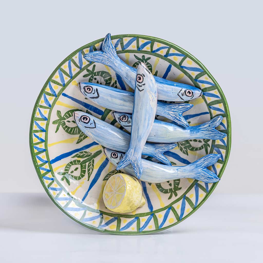 Ceramic still life with sardines and half a lemon, handmade and painted in a unique & colourful style by Spanish artist Maite Morell.