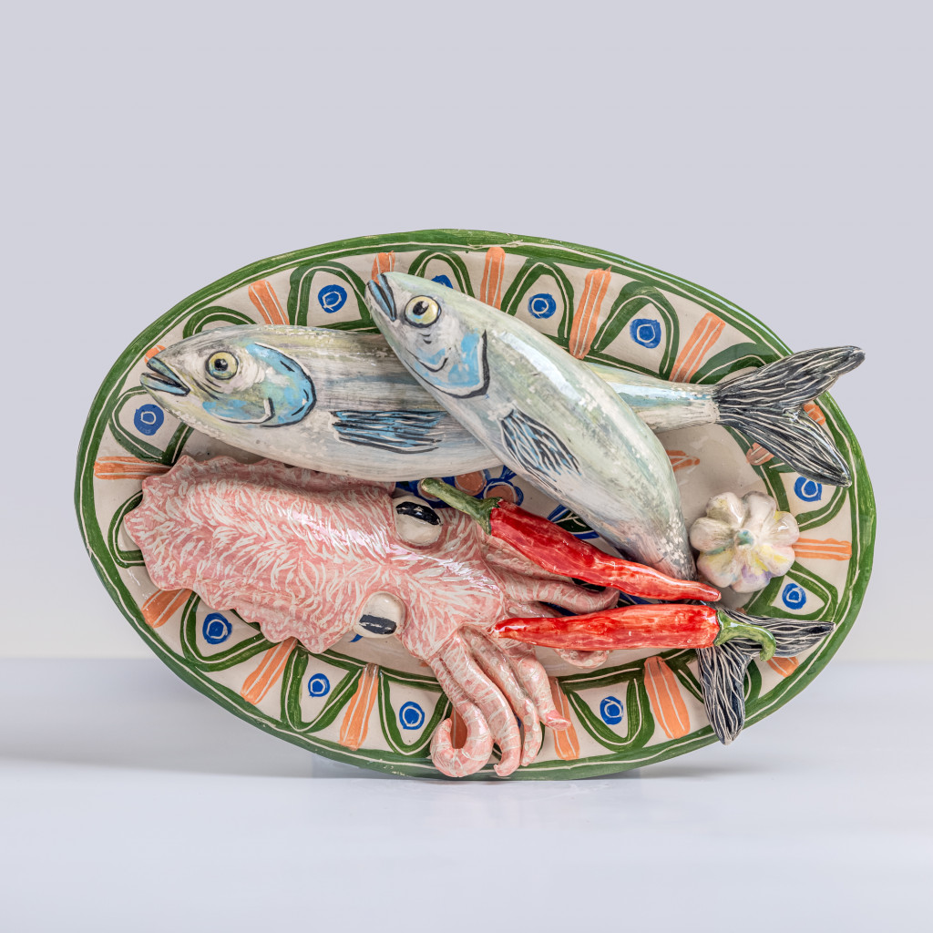 Ceramic still life with sea bass, cuttlefish, chili and a head of garlic, handmade and painted in a unique & colourful style by Spanish artist Maite Morell.