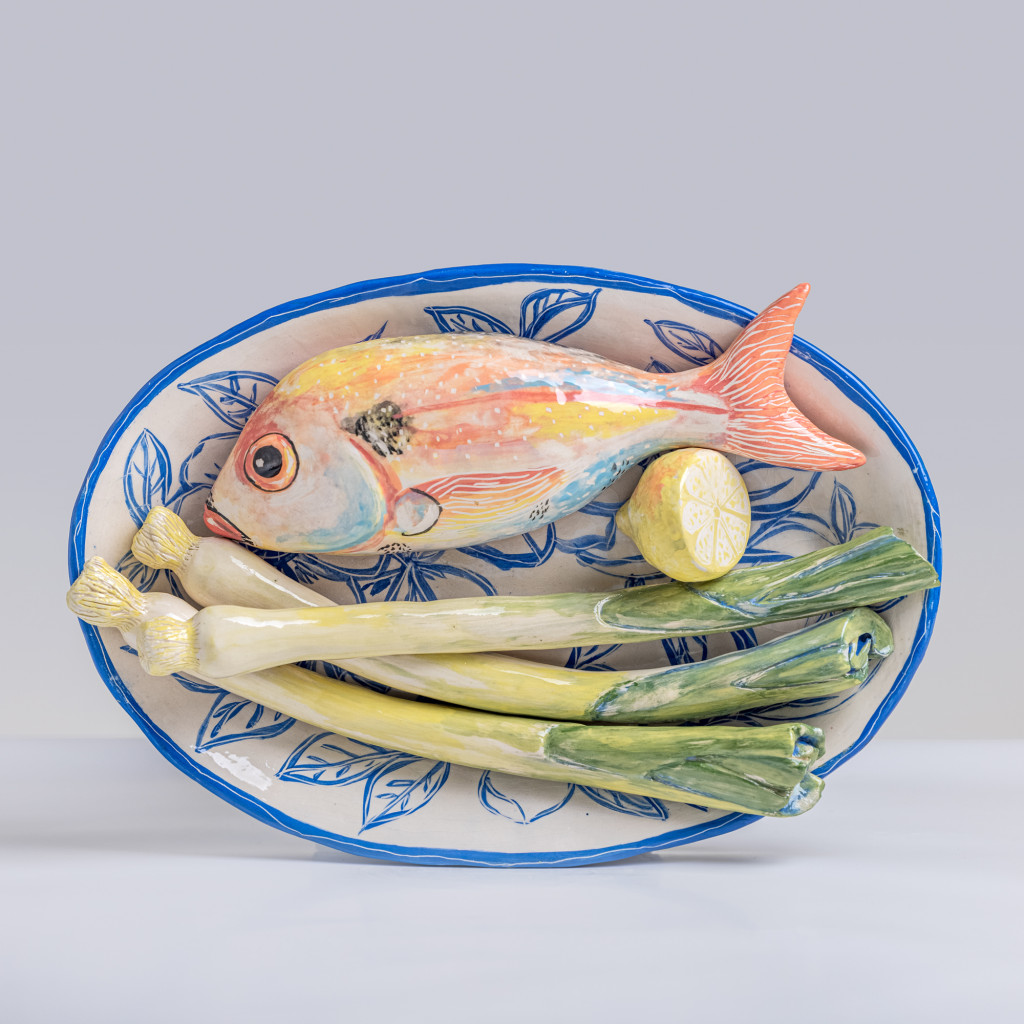 Ceramic still life with sea bream, leeks and half a lemon, handmade and painted in a unique & colourful style by Spanish artist Maite Morell.