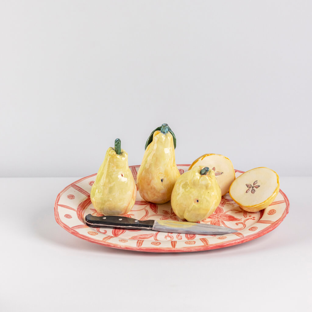 Ceramic still life of a tray of four quinces and a knife, handmade and painted in a unique & colourful style by Spanish artist Maite Morell.