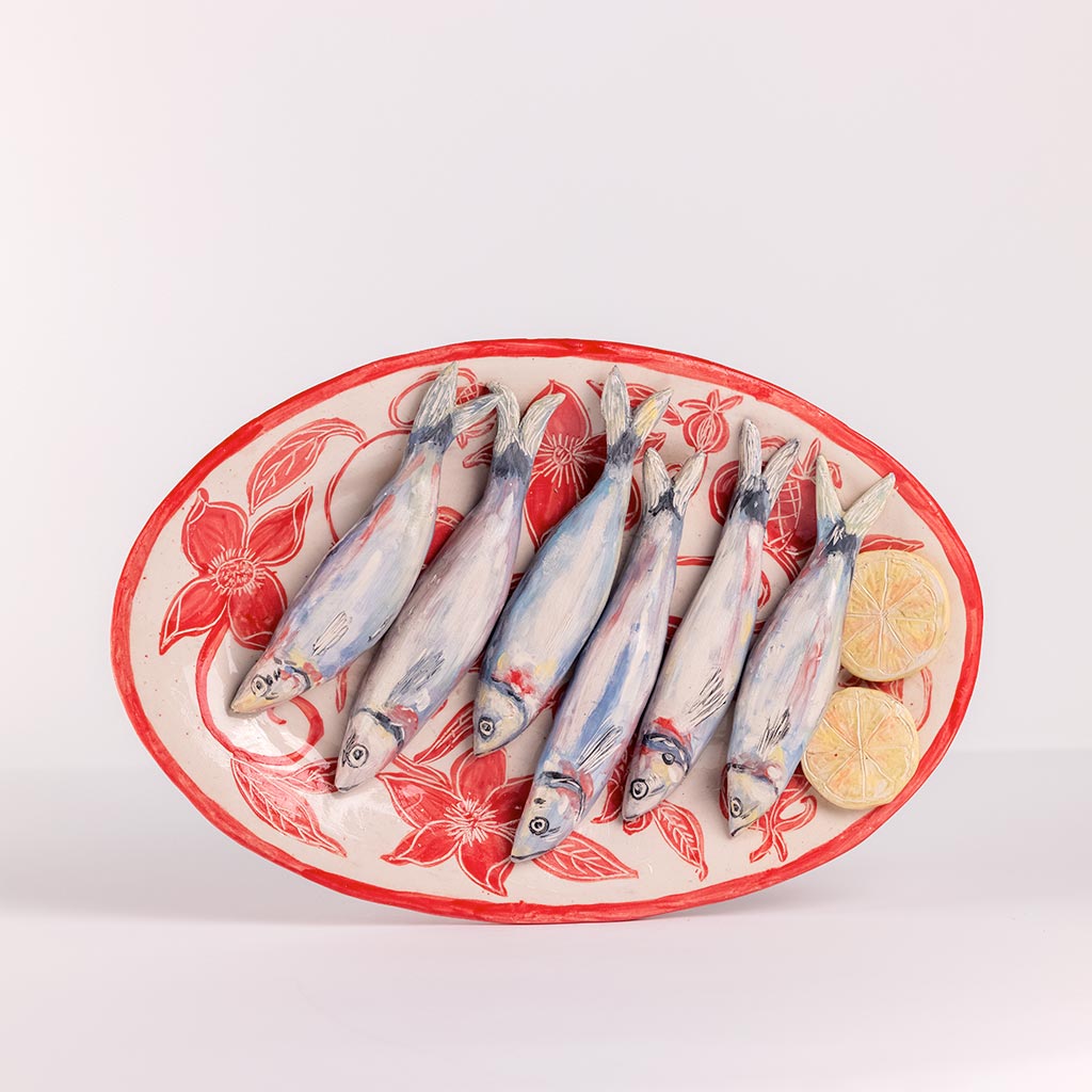 Ceramic still life with sardines on a tray with red flowers, handmade and painted in a unique style by Spanish artist Maite Morell.