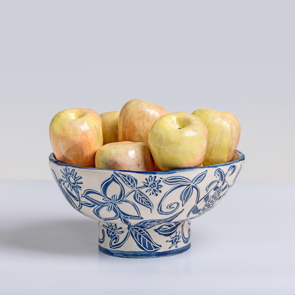 Ceramic still life of a bowl with yellow apples, handmade and painted in a unique & colourful style by Spanish artist Maite Morell.