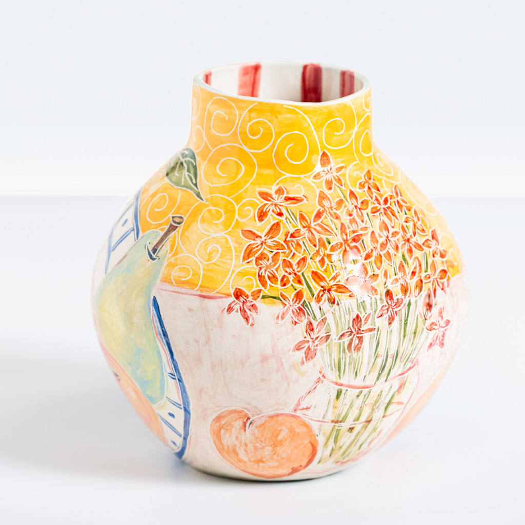 Ceramic vase with vase of flowers and fruit plate on yellow background, handmade and painted in a unique & colourful style by Spanish artist Maite Morell.