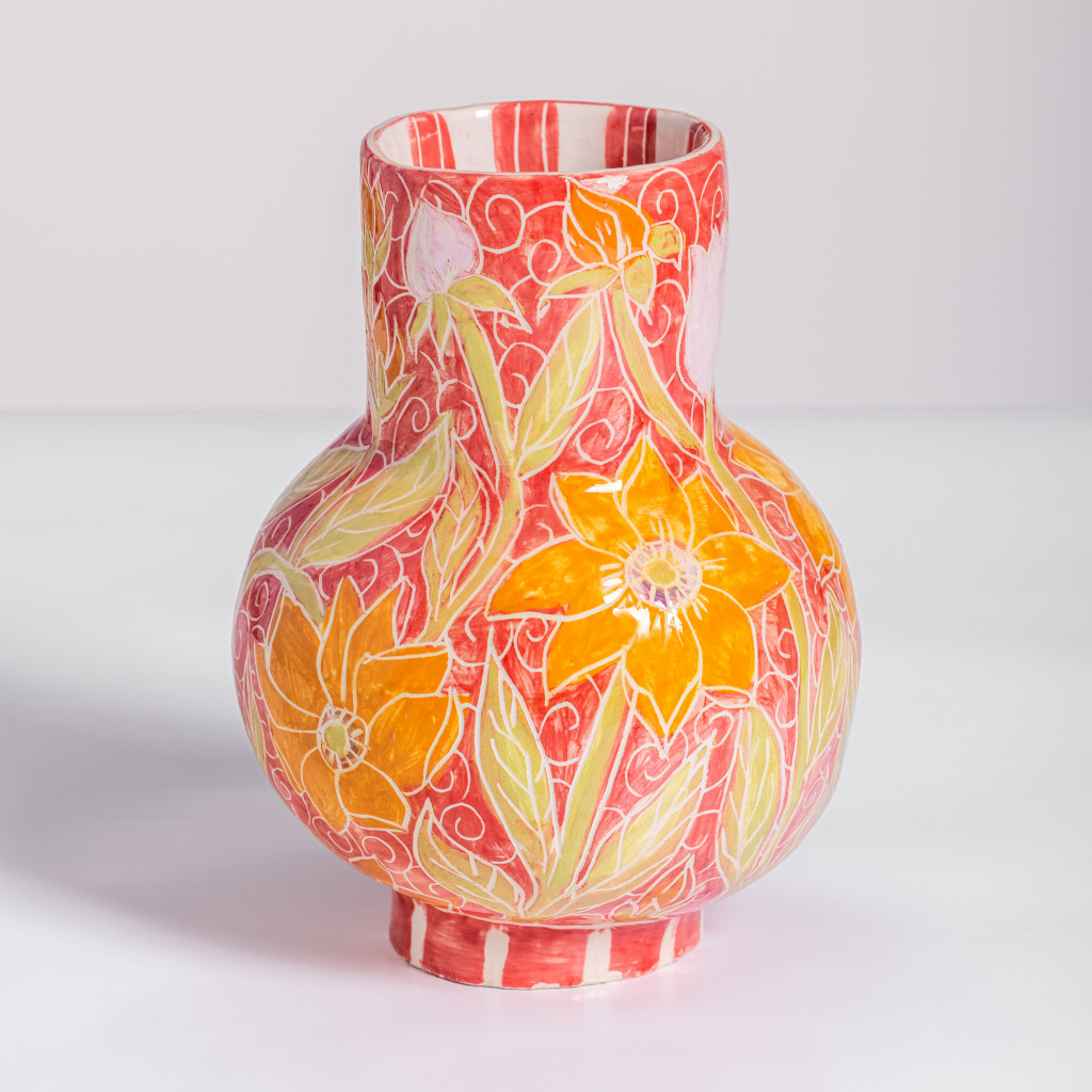 Ceramic vase with flowers and green branches on intense red background, handmade and painted in a unique style by Spanish artist Maite Morell.