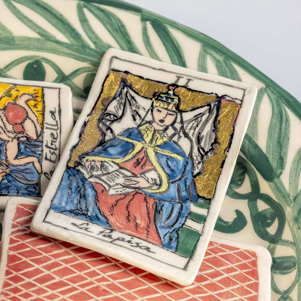 Ceramic still life of a green plate with tarot cards, handmade and painted in a unique style by Spanish artist Maite Morell.