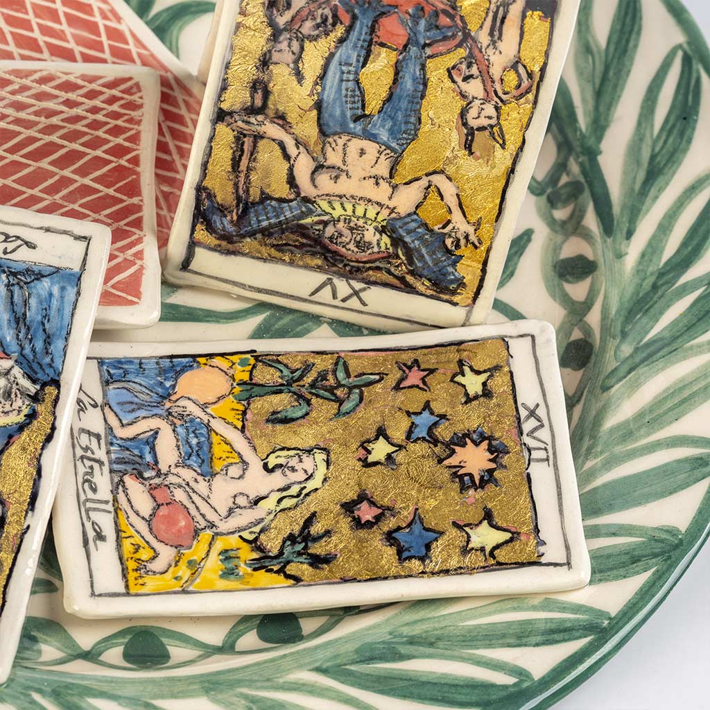 Ceramic still life of a green plate with tarot cards, handmade and painted in a unique style by Spanish artist Maite Morell.