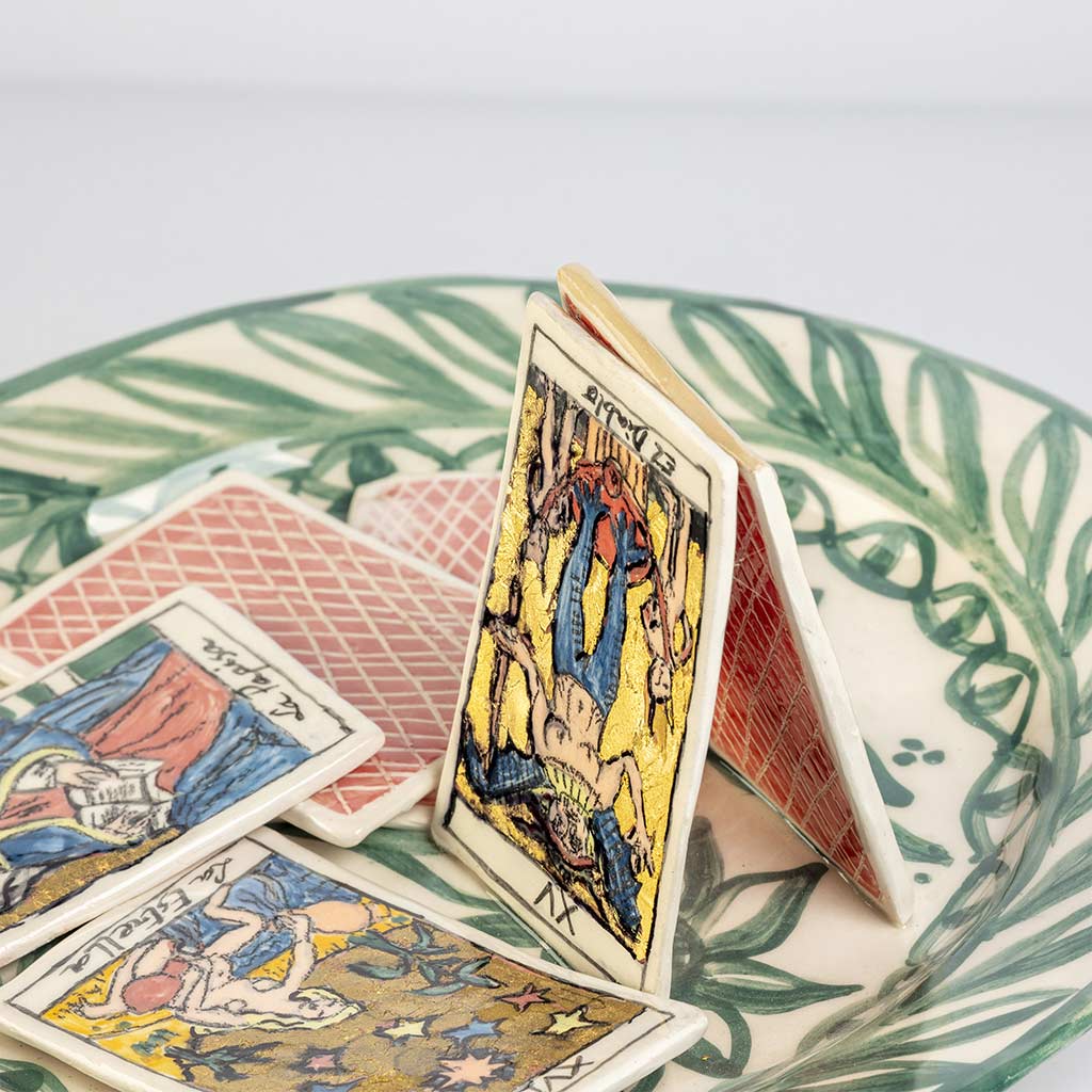 Ceramic still life of a green plate with tarot cards, handmade and painted in a unique style by Spanish artist Maite Morell.