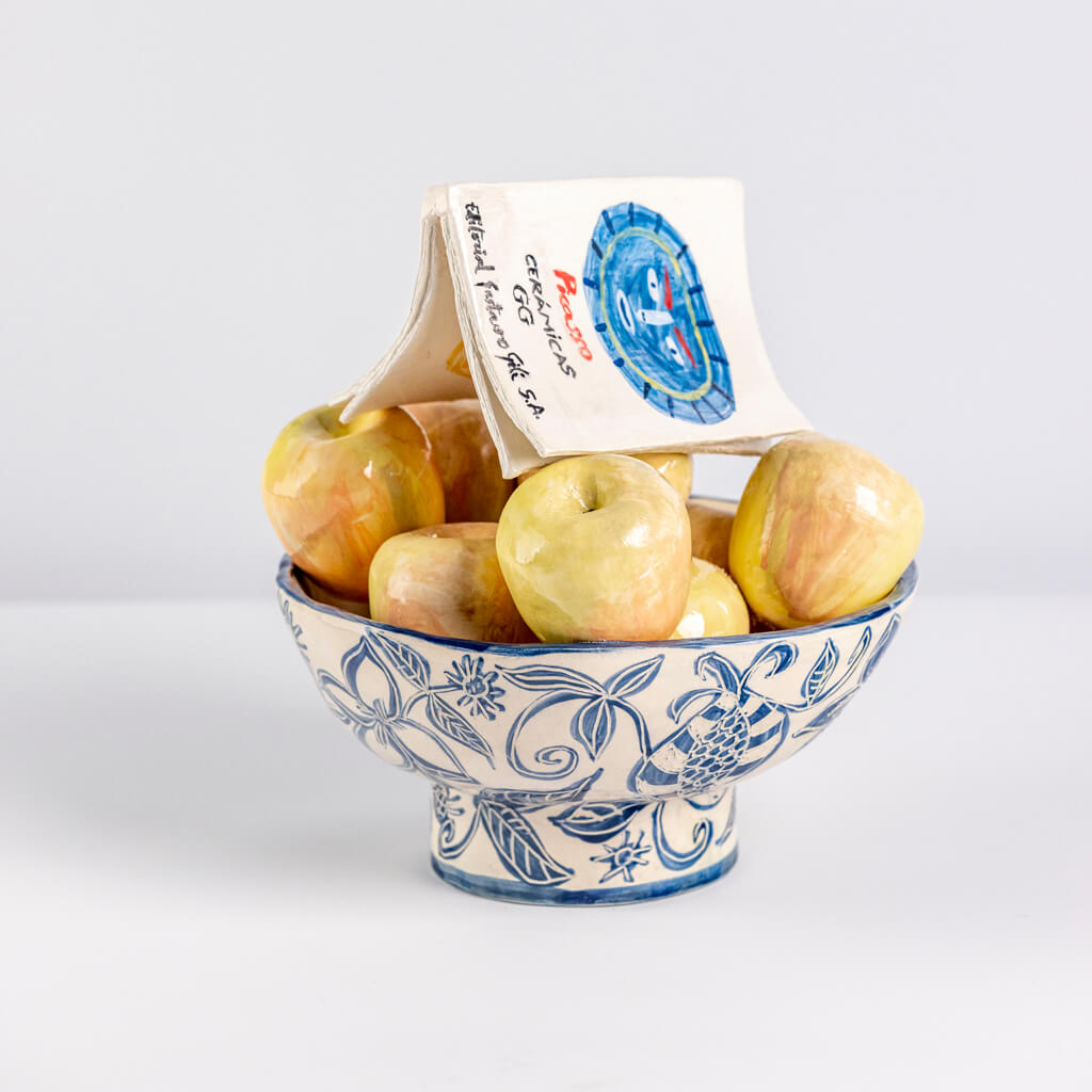 Ceramic still life of a fruit bowl, apples and a Picasso ceramics book, handmade and painted in a unique & colourful style by Spanish artist Maite Morell.