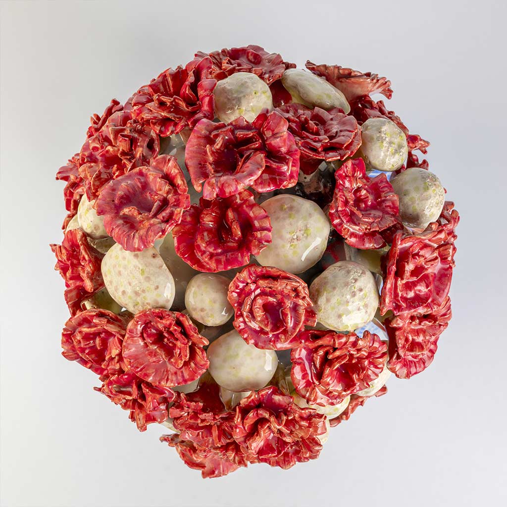 Ceramic still life of a klein blue vase with red carnations, handmade and painted in a unique style by Spanish artist Maite Morell.