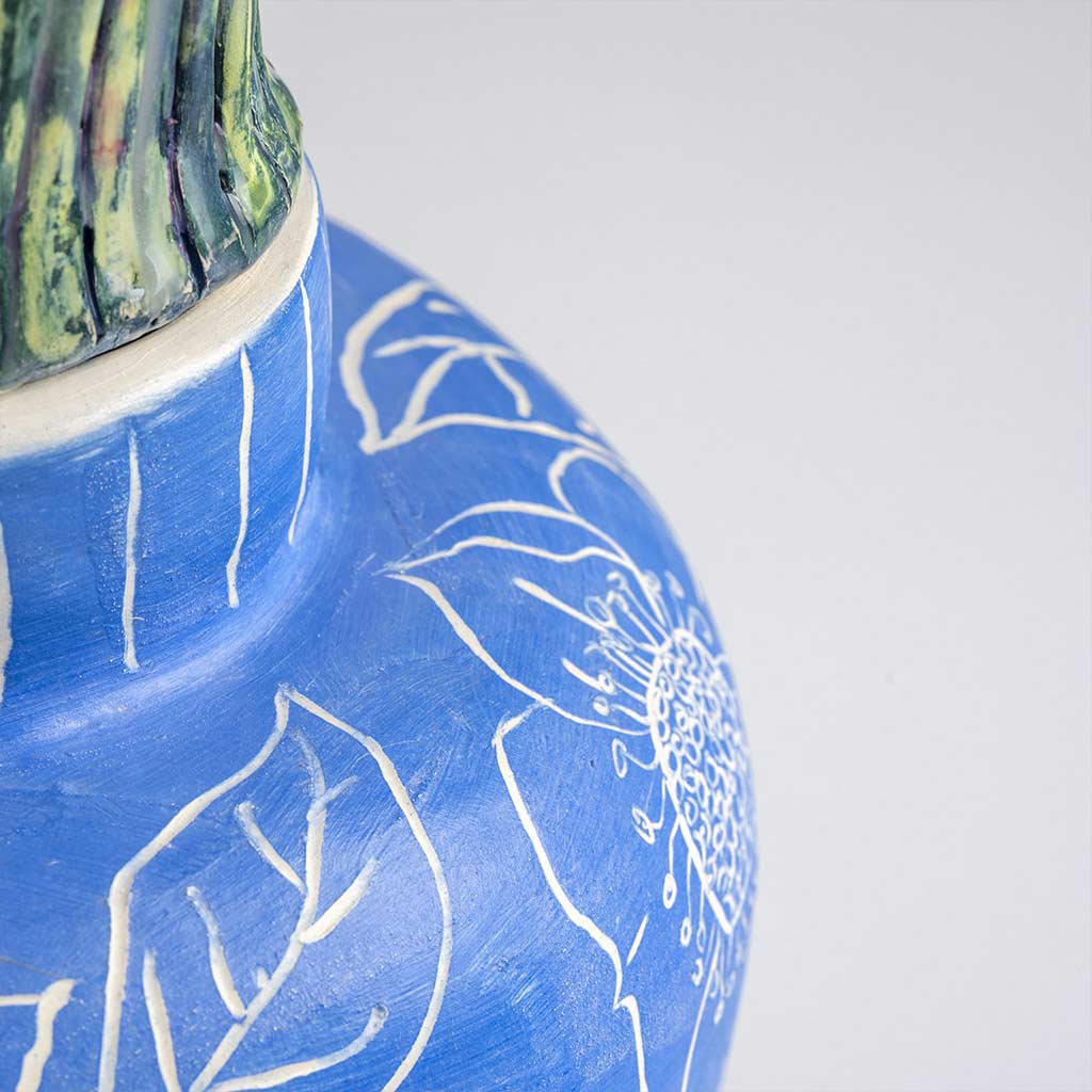 Ceramic still life of a klein blue vase with red carnations, handmade and painted in a unique style by Spanish artist Maite Morell.