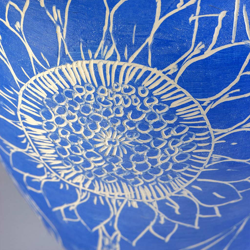 Ceramic still life of a klein blue vase with red carnations, handmade and painted in a unique style by Spanish artist Maite Morell.