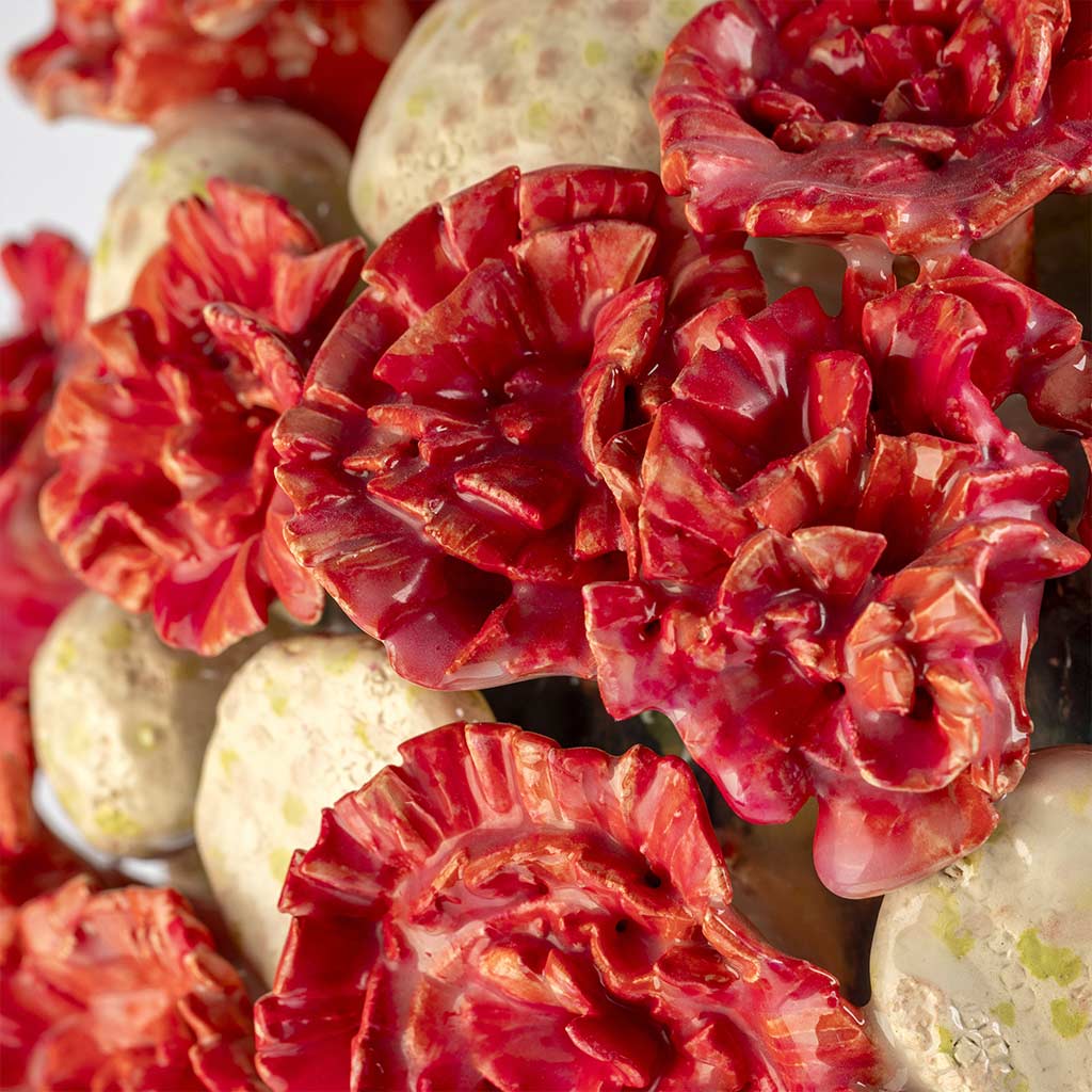 Ceramic still life of a klein blue vase with red carnations, handmade and painted in a unique style by Spanish artist Maite Morell.